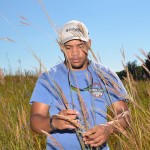 ECC Conservation Technology student studying plants in meadow